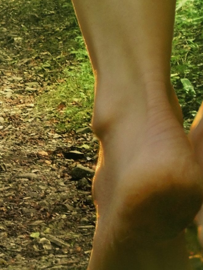 Bare feet walking along a forest path, from the cover of The Ugly Foot